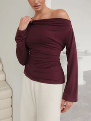 Side angle showing the slim fit and smooth drape of the long sleeve knit top.
