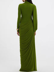 Full-length view highlighting the slim, floor-length silhouette and long sleeves, with fabric falling smoothly to the hem in a sleek line.