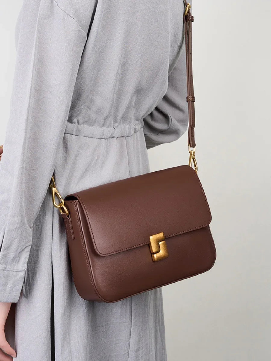 Leather crossbody with secure zipper and hasp closure detail