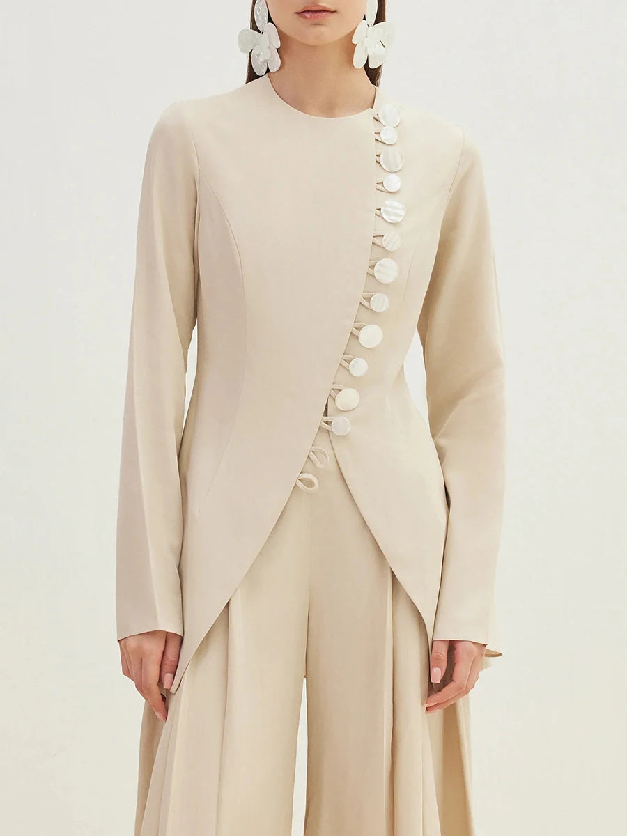 A woman modeling a solid button-up jacket with a round neckline.