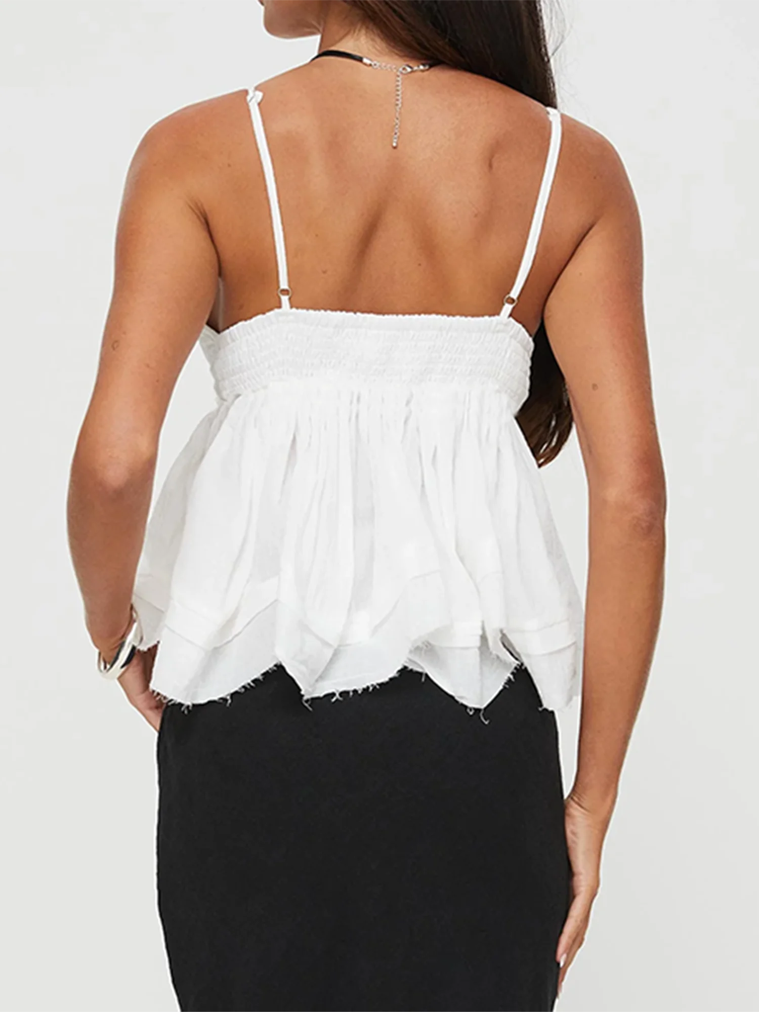 A close-up of the solid-color sleeveless top, showing the ruffle detail.