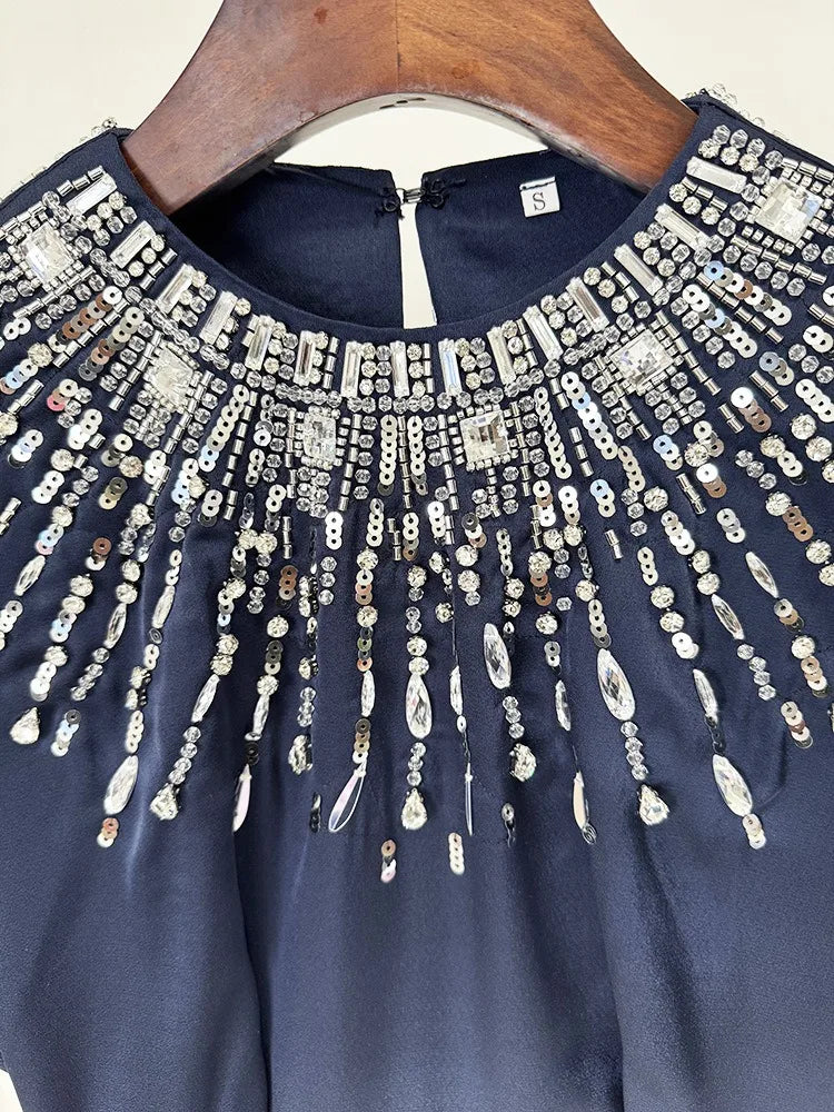 Sophisticated wedding guest gown in navy with embroidered accent