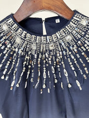 Sophisticated wedding guest gown in navy with embroidered accent