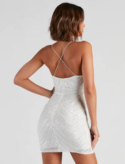 Woman wearing a sparkling V-neck above-knee dress designed for cocktail gatherings with a backless design on a plain background