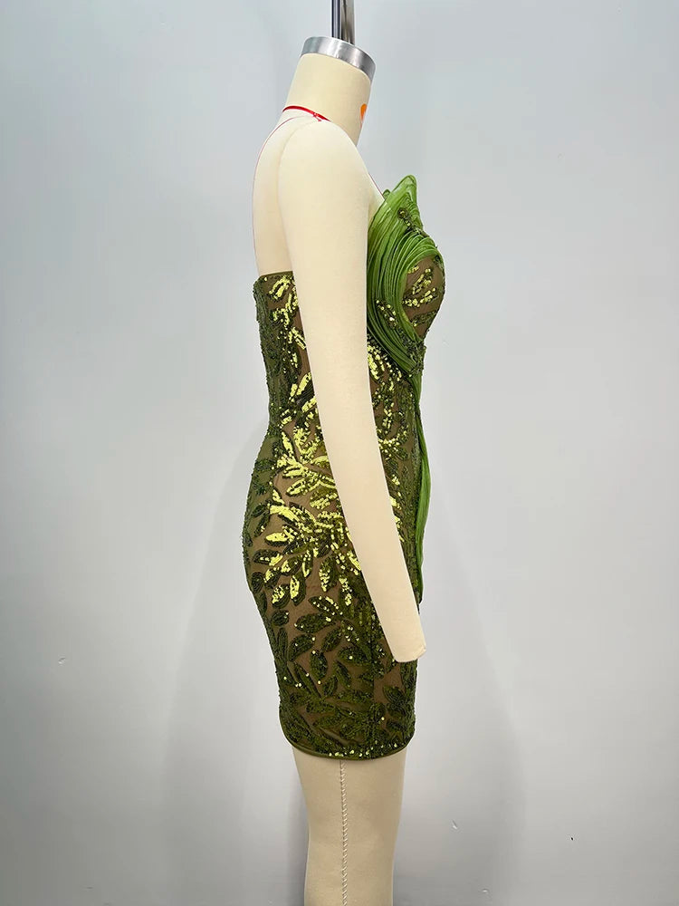 Sparkly cocktail 3D mesh gown for women with sculptural details. Green sequin dress on a mannequin against a gray background