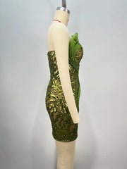 Sparkly cocktail 3D mesh gown for women with sculptural details. Green sequin dress on a mannequin against a gray background