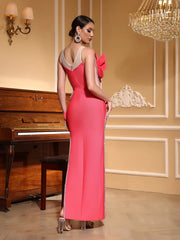 Woman in a sparkly, floral appliqué evening gown in pink for standout events in an elegant room with a piano and chandelier.