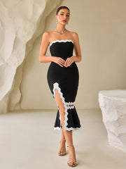 Woman wearing a Split bandage bodycon evening gown in black and white for an events setting.