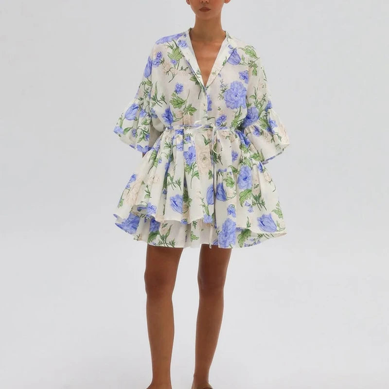 Stand collar A-line office chic dress shown with long sleeves and flower print on a plain background