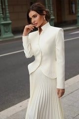 Two-piece set styled for an elegant daytime look, highlighting the structured top and flowing skirt.