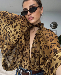 Statement animal print sheer blouse displayed for modern layering style