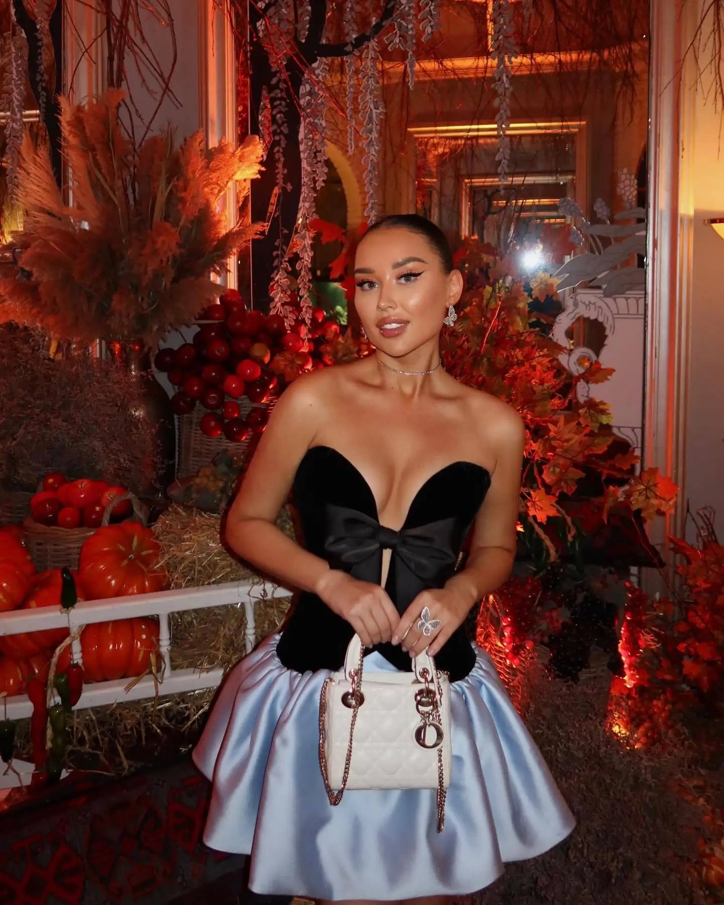 Statement bow strapless party mini dress shown on city background