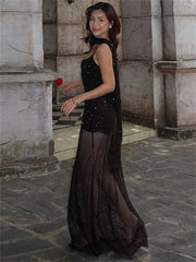 Statement black dress with mesh overlay and minimal heels