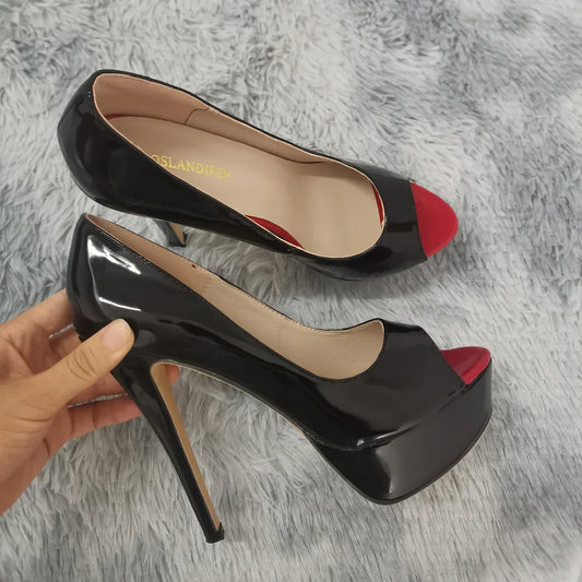 Stiletto high heel party shoe in glossy black patent leather on a grey textured surface