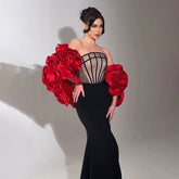 Strapless black mermaid gown with corset bodice and red floral sleeves