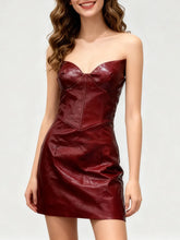 A strapless faux-leather mini dress with sculpted bodice and confident evening styling against a clean white background.
