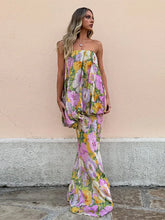 model wearing strapless pastel floral maxi dress outdoors