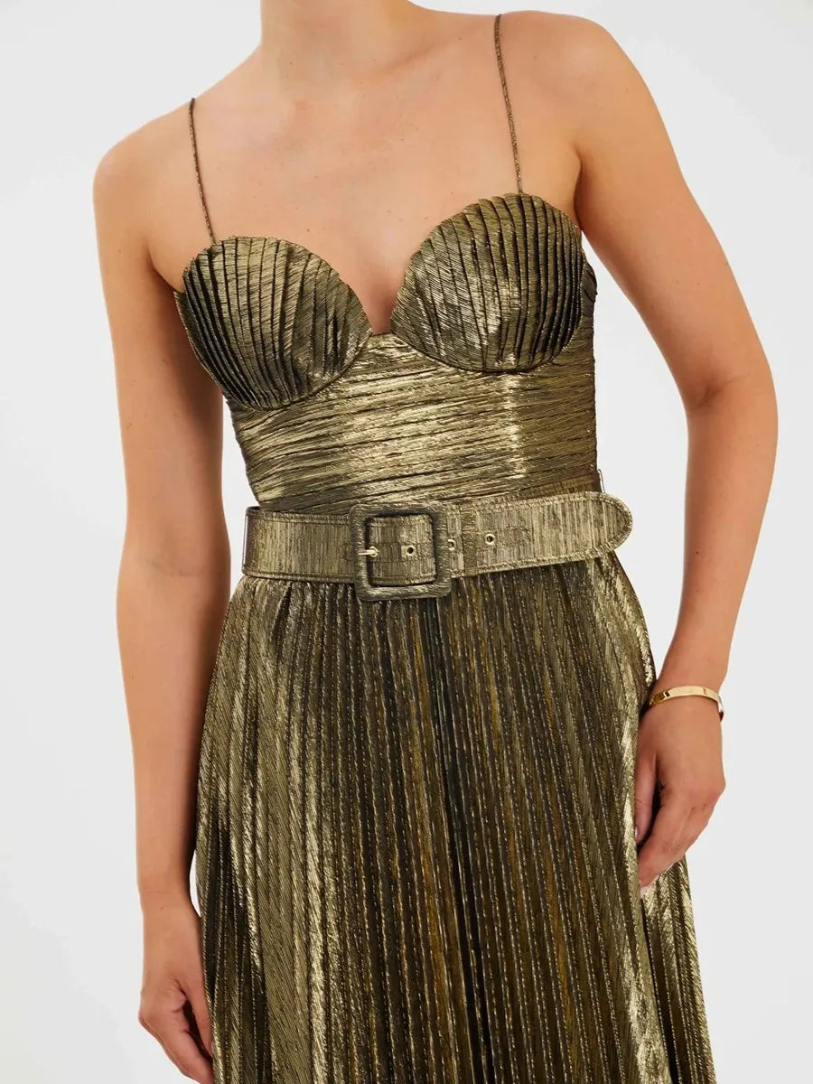 Close-up view of a strapless gold maxi dress with a fitted waistline.