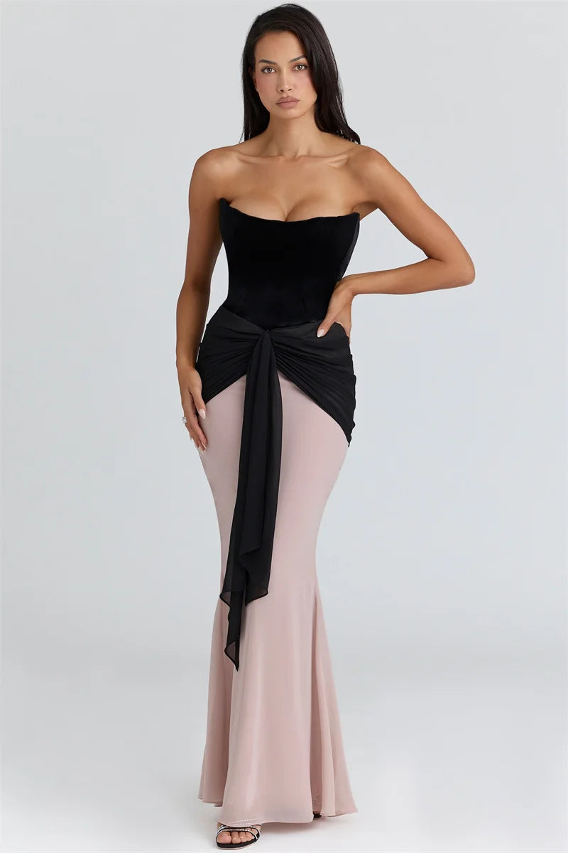 Full-length view of the sculpted corset bodice and flowing maxi skirt highlighting the dress’s elegant drape and structure.