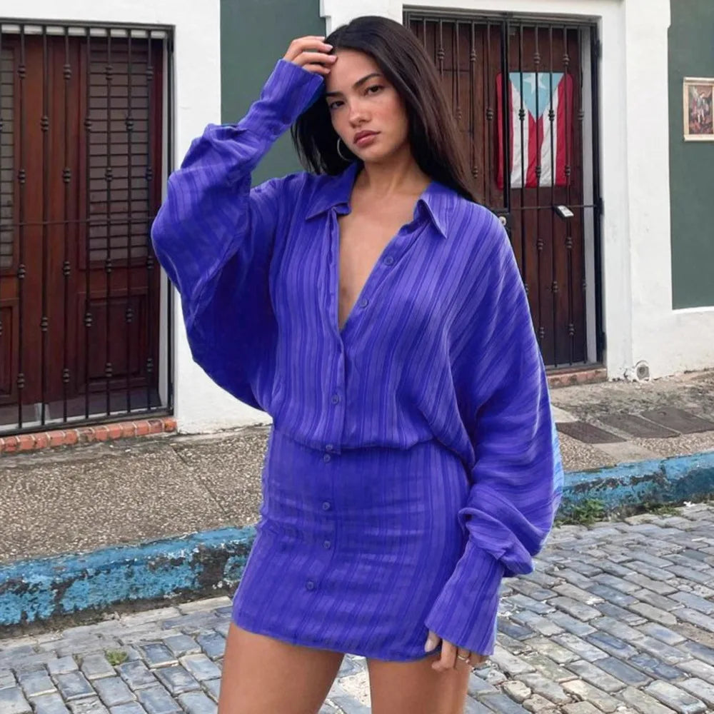 A woman modeling a striped polo long-sleeve mini dress.