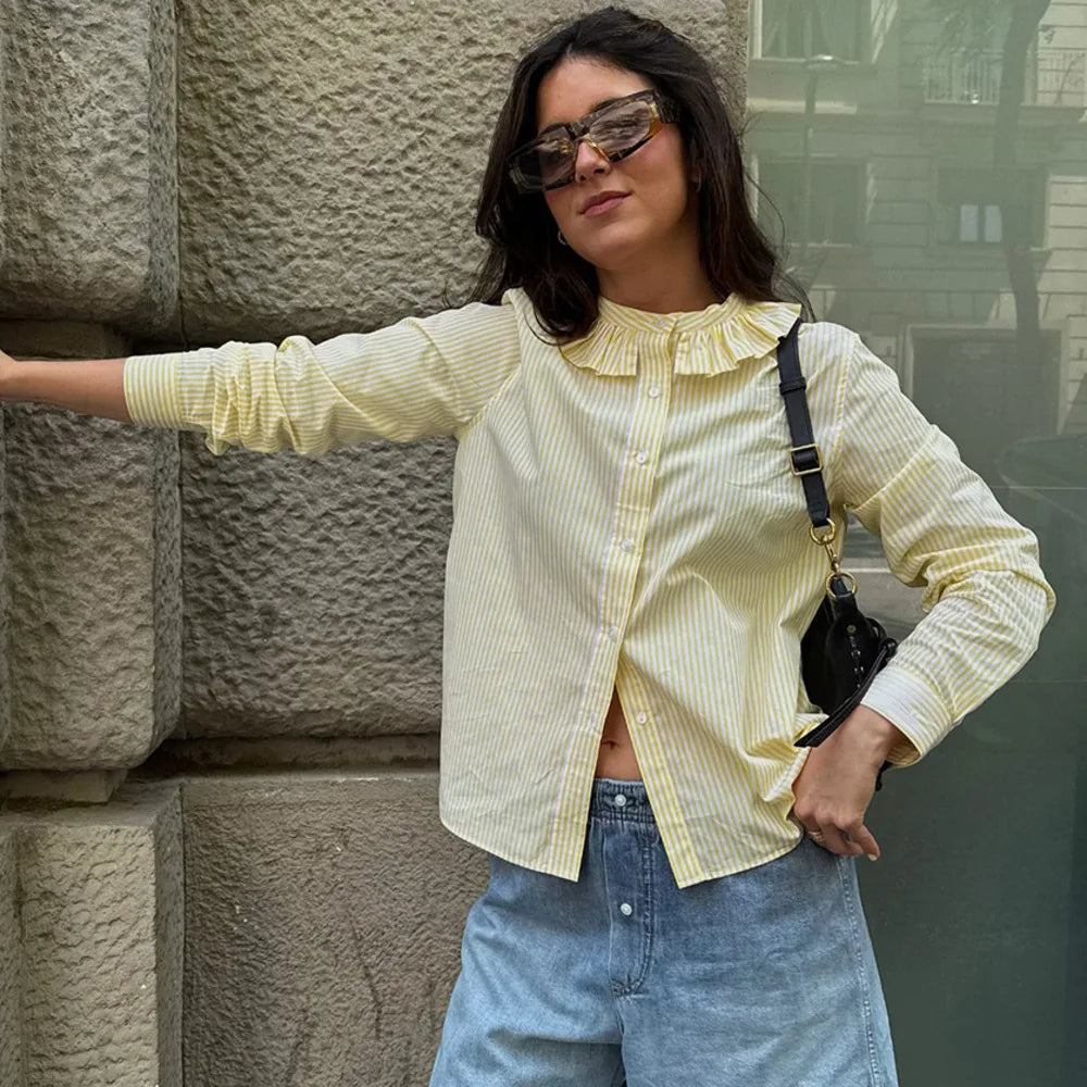 A woman modelling a striped, round-neck, long-sleeve shirt.