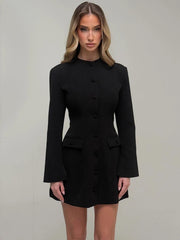 Women’s black blazer mini dress styled with natural waist