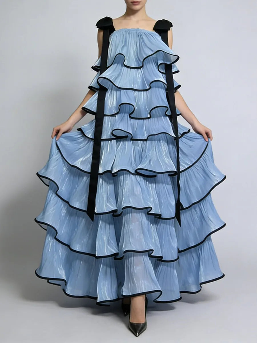 Detail view highlighting contrast edged ruffle layers and clean square neckline construction with sculptural tier spacing and fluid hem movement