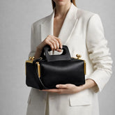 structured top handle shoulder bag with rectangular silhouette and hasp closure