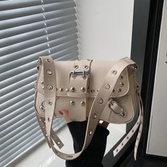 Detail shot of the strap with grommets and studded trim, showing the tough-luxe styling and adjustable-looking construction.