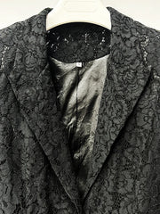 Black lace garment with satin lining on a hanger