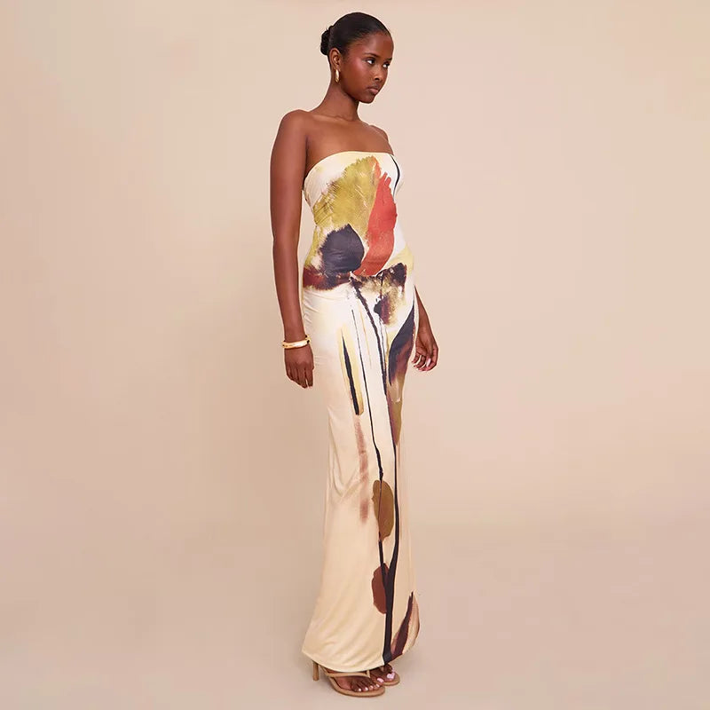 Woman wearing a backless strapless dress in earthy abstract print on a beige background