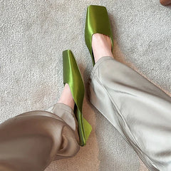 Vibrant green summer wedge heel slides on beige carpet
