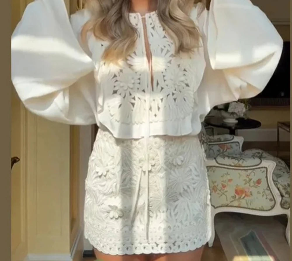A woman wearing a romantic lace two-piece co-ord outfit for spring and summer in a home setting