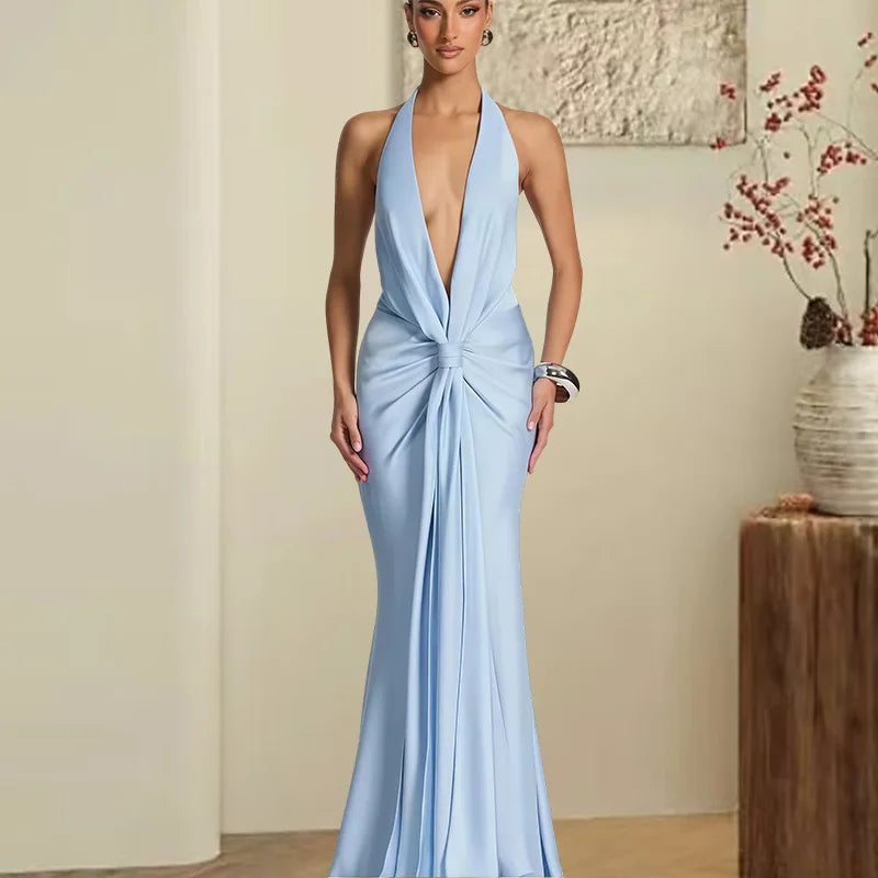 Deep V halter maxi dress displayed with flowing satin drape.