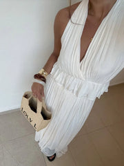 Backless white crop top and flowy skirt for formal beach moments