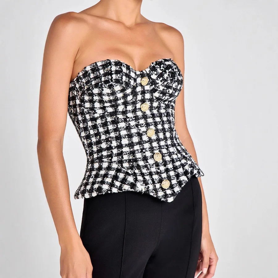 Detail view of the strapless neckline curve, highlighting the fitted corset construction and clean edge finish across the bust.