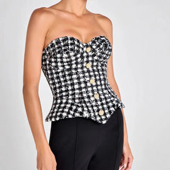 Detail view of the strapless neckline curve, highlighting the fitted corset construction and clean edge finish across the bust.