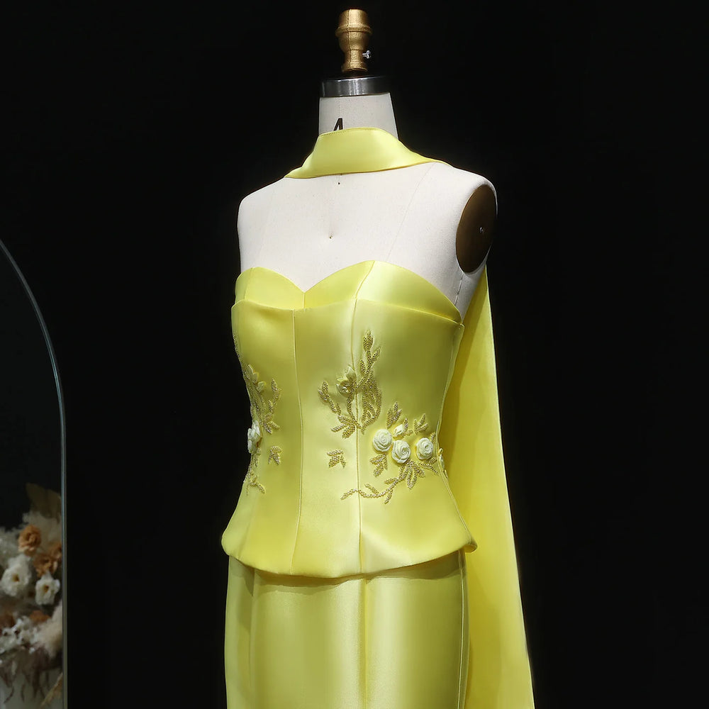 Yellow dress on a mannequin against a black background