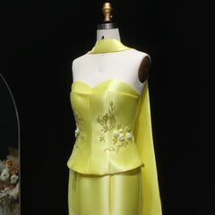 Yellow dress on a mannequin against a black background
