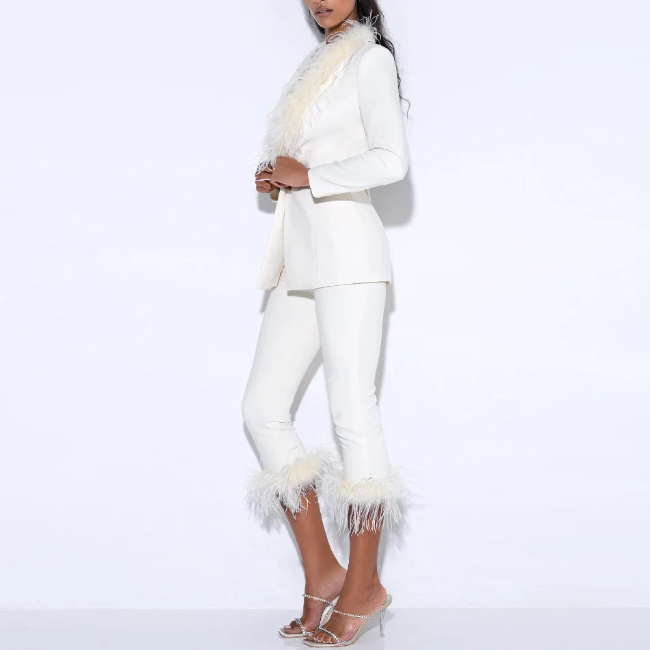 Close view highlighting feather detailing along the blazer lapel and sharp tailored neckline