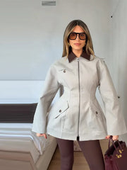 Close-up of lapel collar and zipper detail on structured jacket