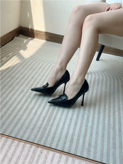 Slip-on tan pointed toe pumps are available in large and small sizes for banquet wear, worn by a person on a textured floor.