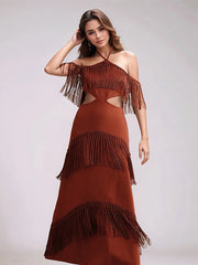Woman wearing a tassel evening party cocktail gown in red for summer celebrations against a plain background