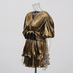 Detail view of the gold shorts showing the elastic waistband and comfortable, loose fit.