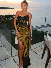 Tiger print mesh dress with open back and side slit on scenic balcony
