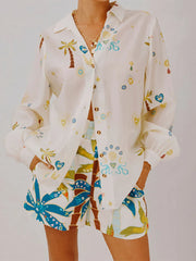 Woman wearing tropical print button-down shirt with matching shorts