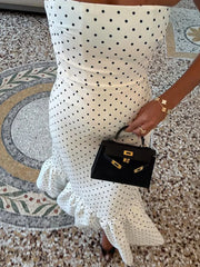 close view of straight strapless bodice on white dotted maxi dress