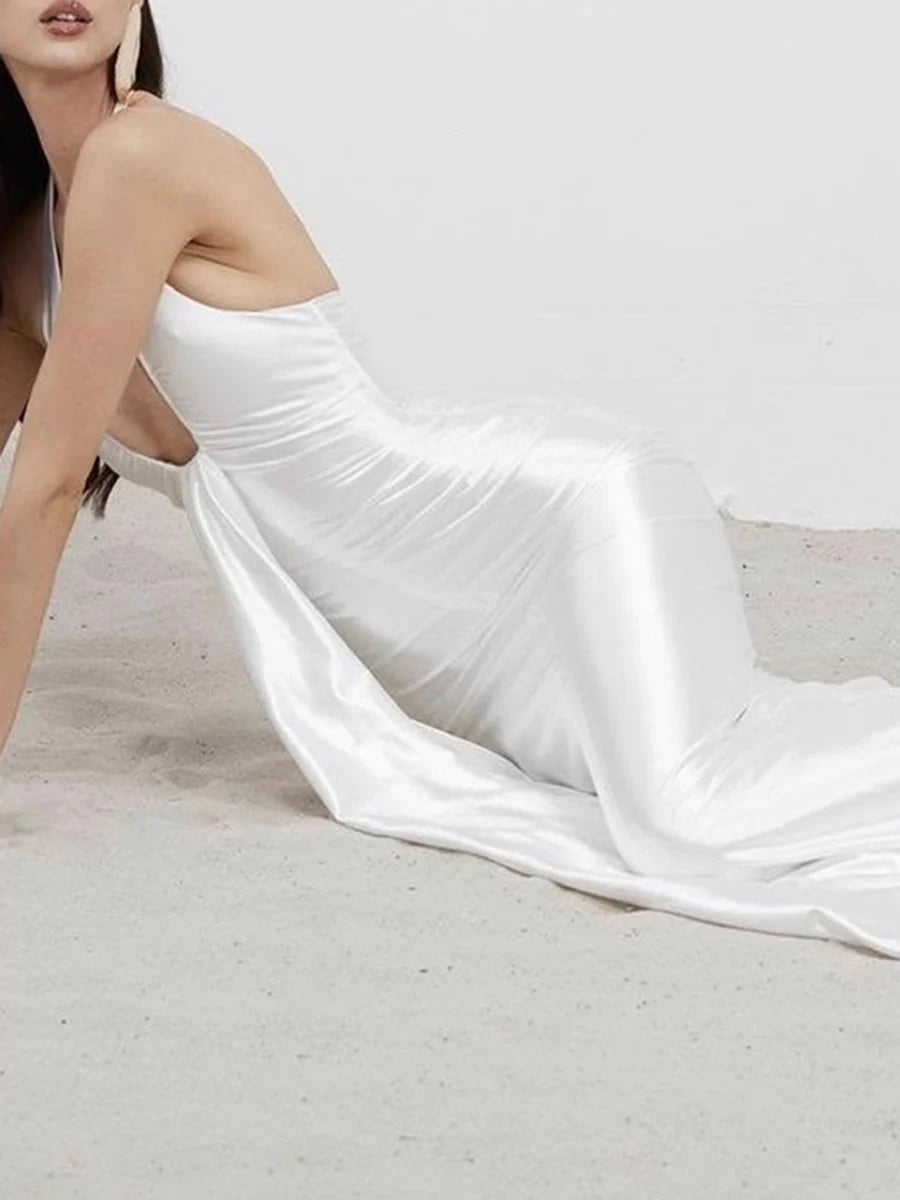 Trumpet silhouette white gala gown modeled at formal celebration