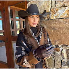 Styling detail showing the turn-down collar and belt tie on a printed knit cardigan, layered over a black base for contrast.