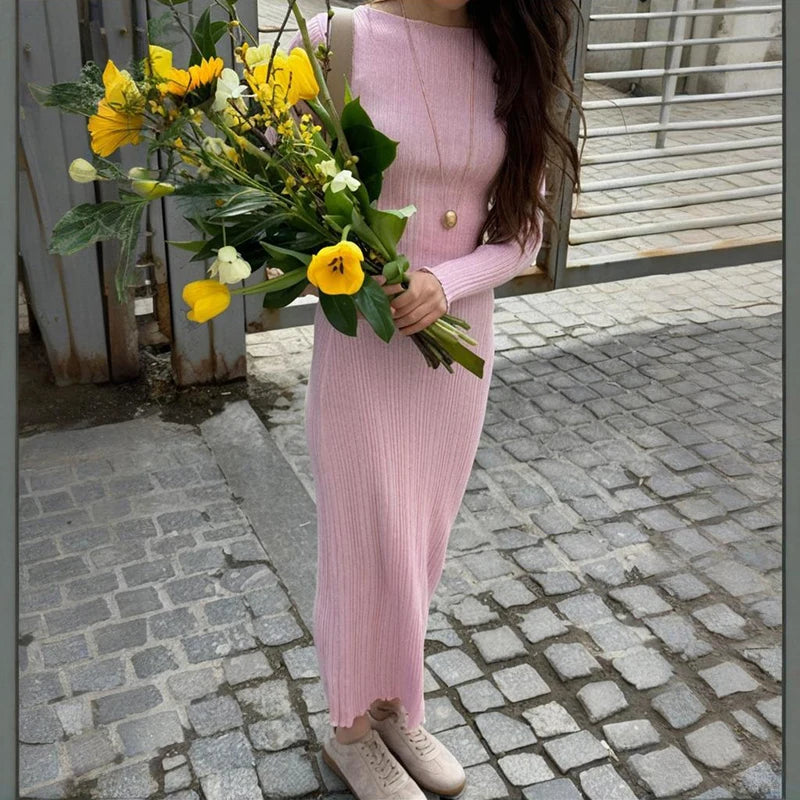 Pink two-piece knit outfit styled with bouquet on street